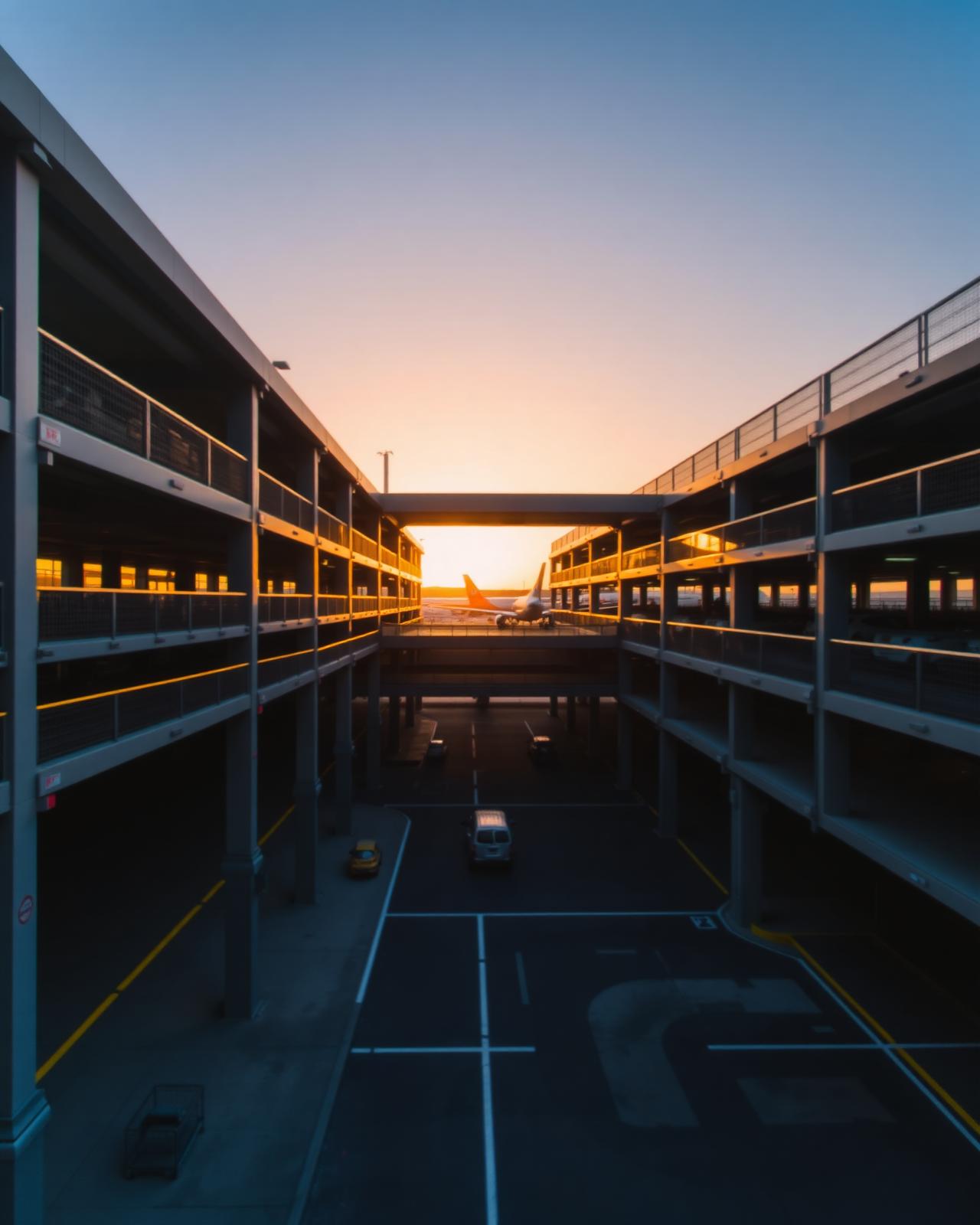 Modern airport multi-story parking structure at sunset